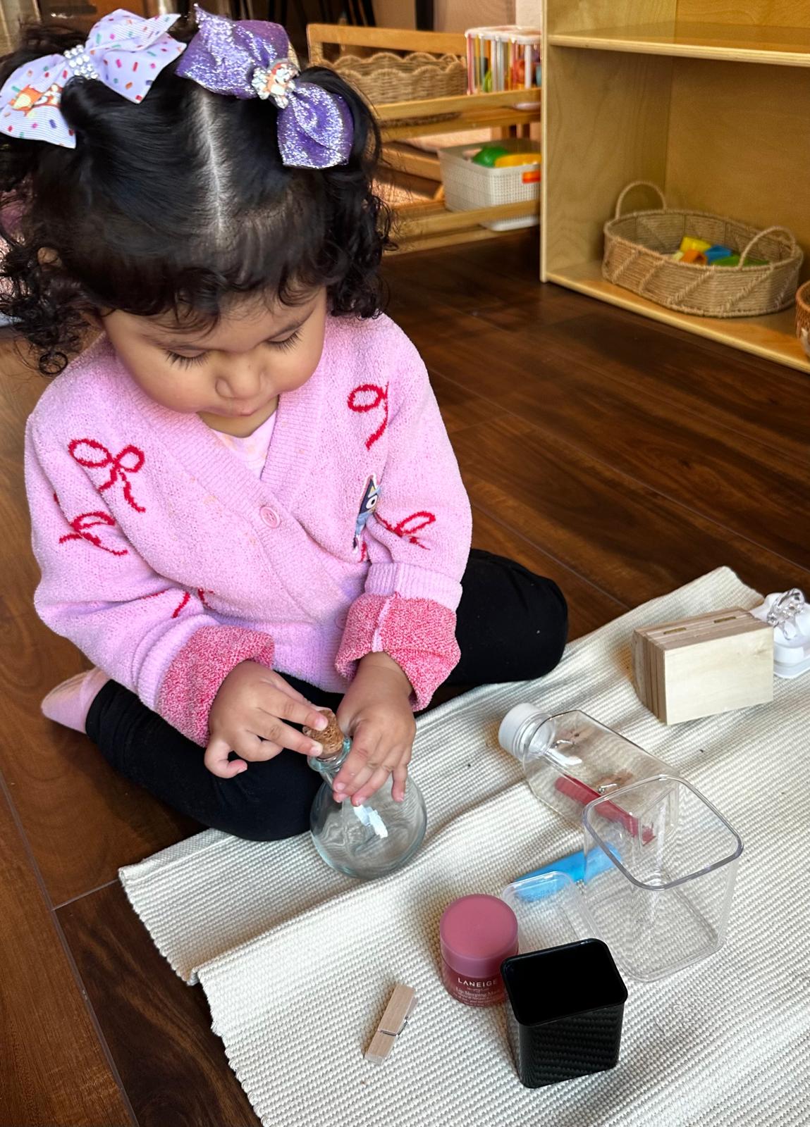 Toddler practicing independence with everyday objects